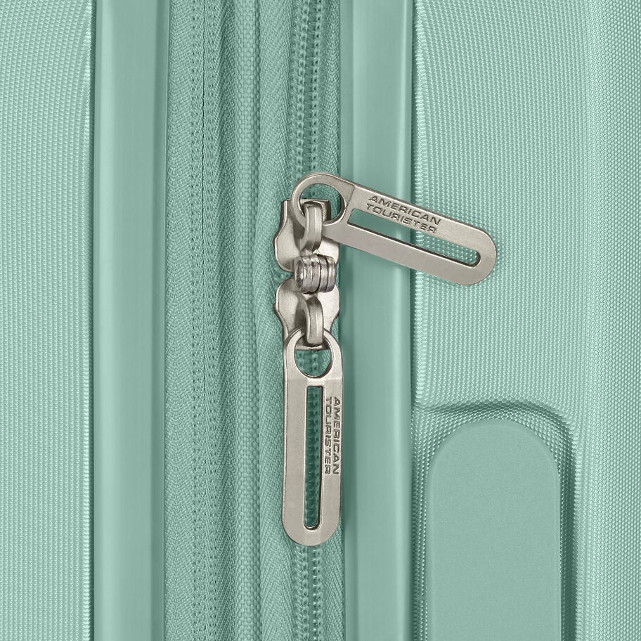 Zipper pulls with American Tourister branding on mint suitcase
