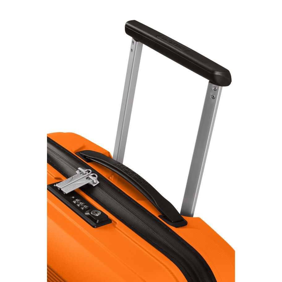 Close-up of zipper and latch on orange carry-on