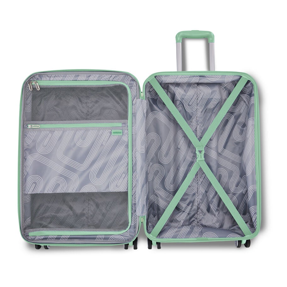 Open mint green carry-on and packing cubes arranged inside