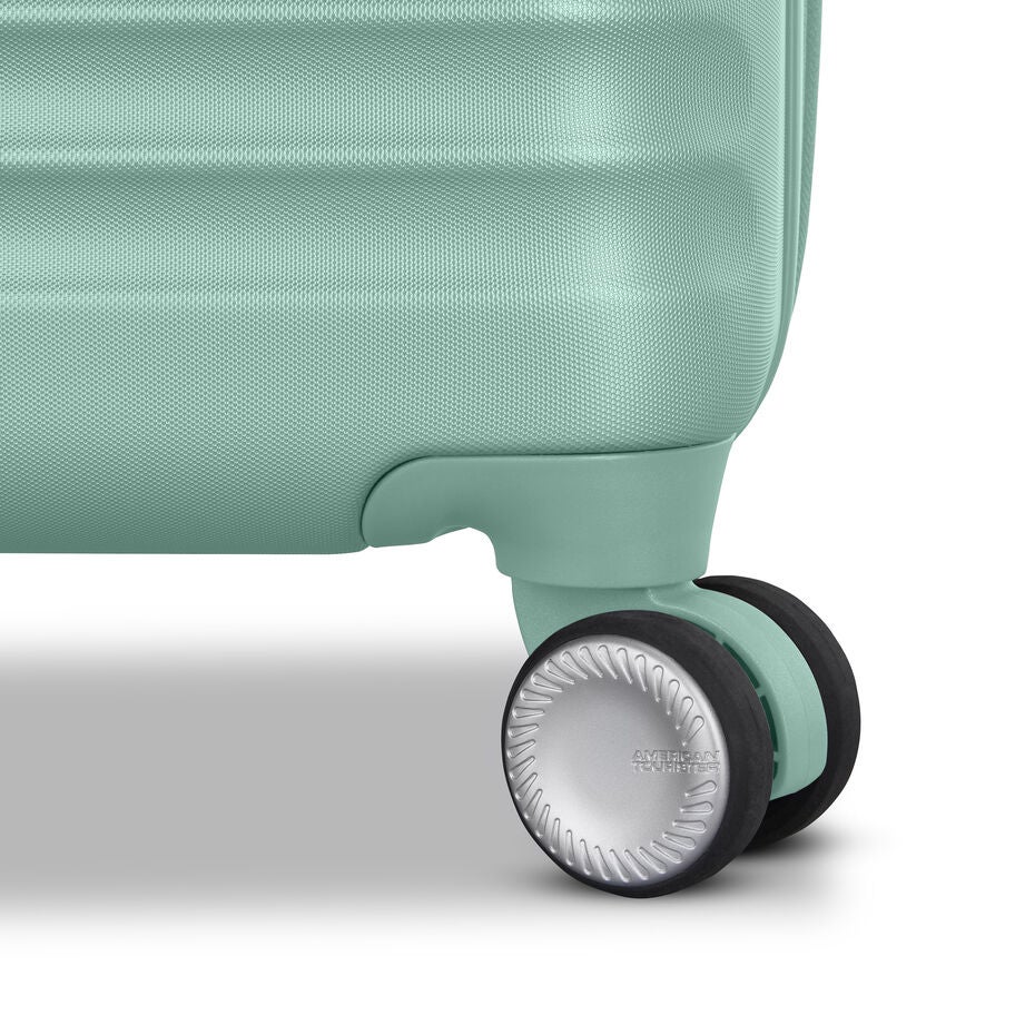 Wheel detail of mint suitcase with prominent tread