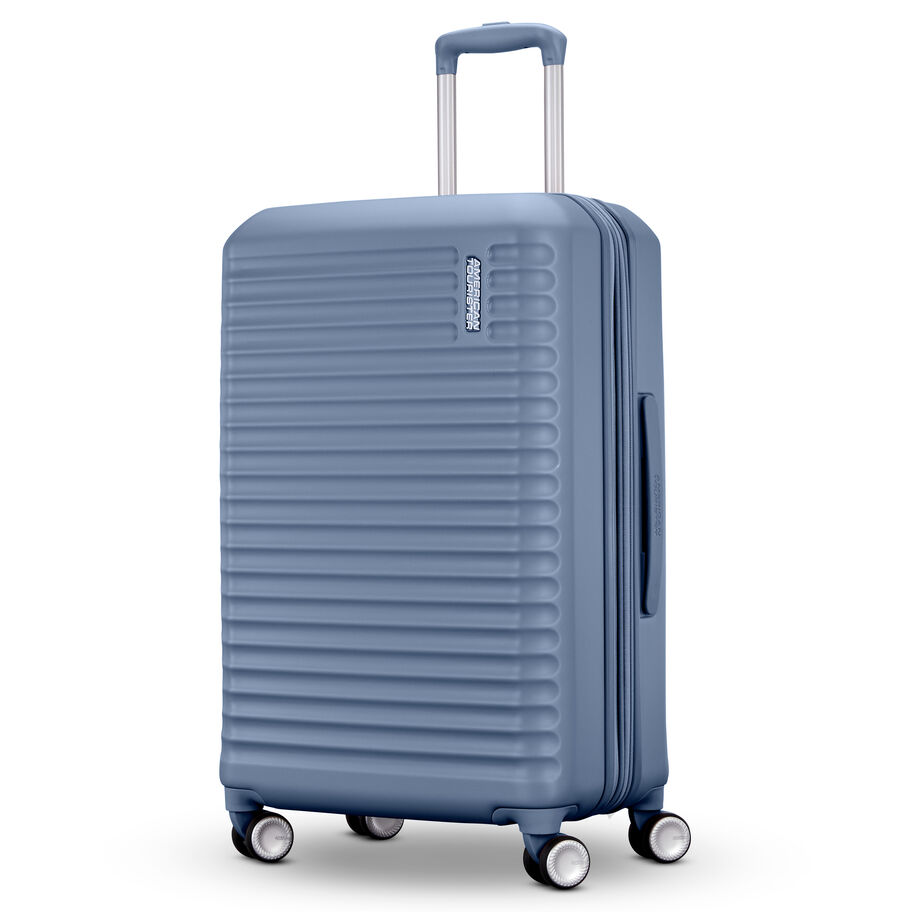 Blue hard-shell suitcase standing with wheels visible