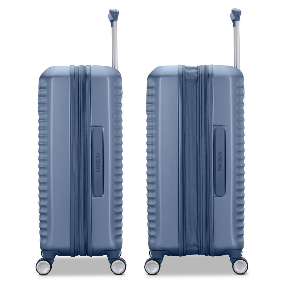 Two blue suitcases standing side by side with extended handles